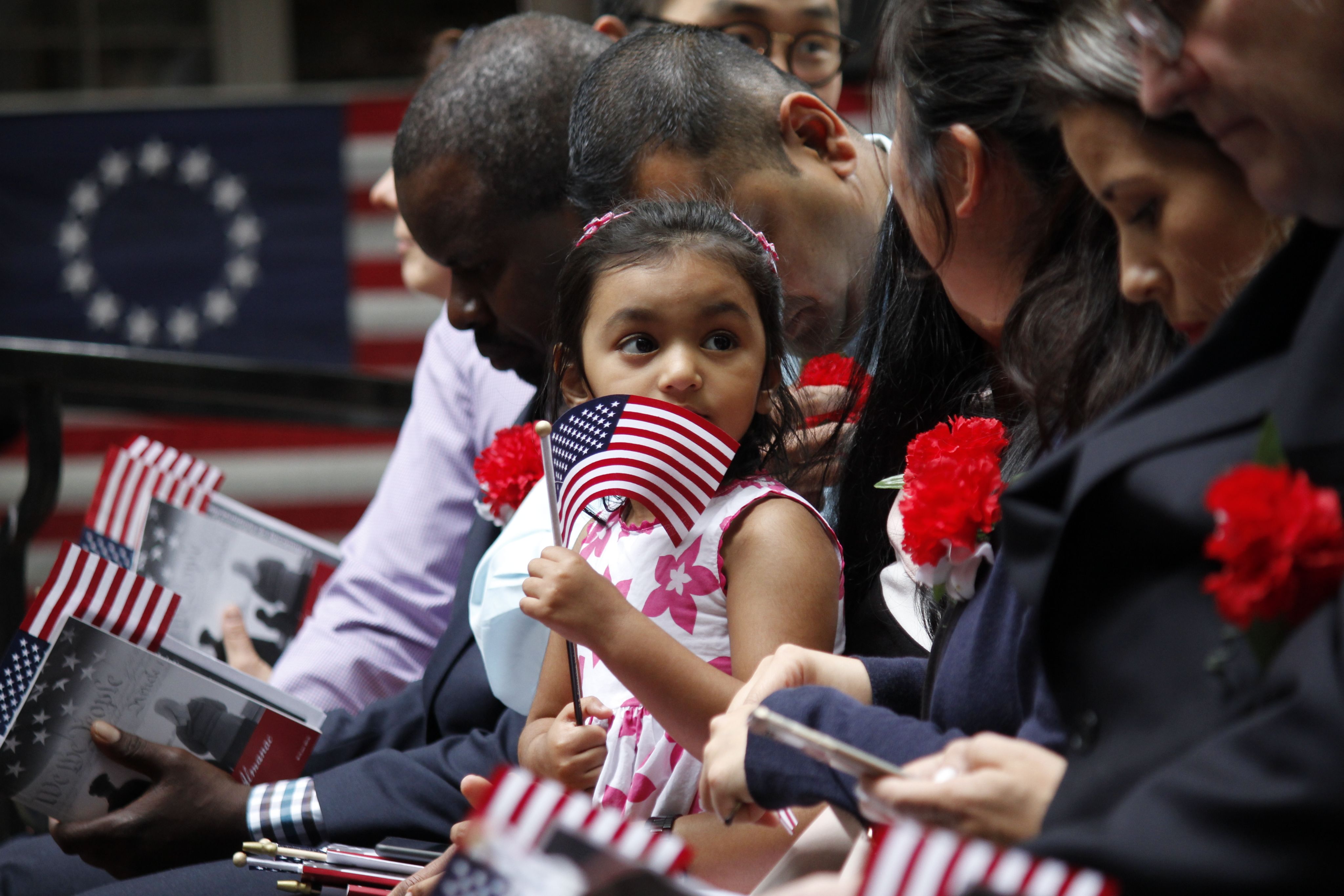 Immigrants becoming naturalized United States citizens.