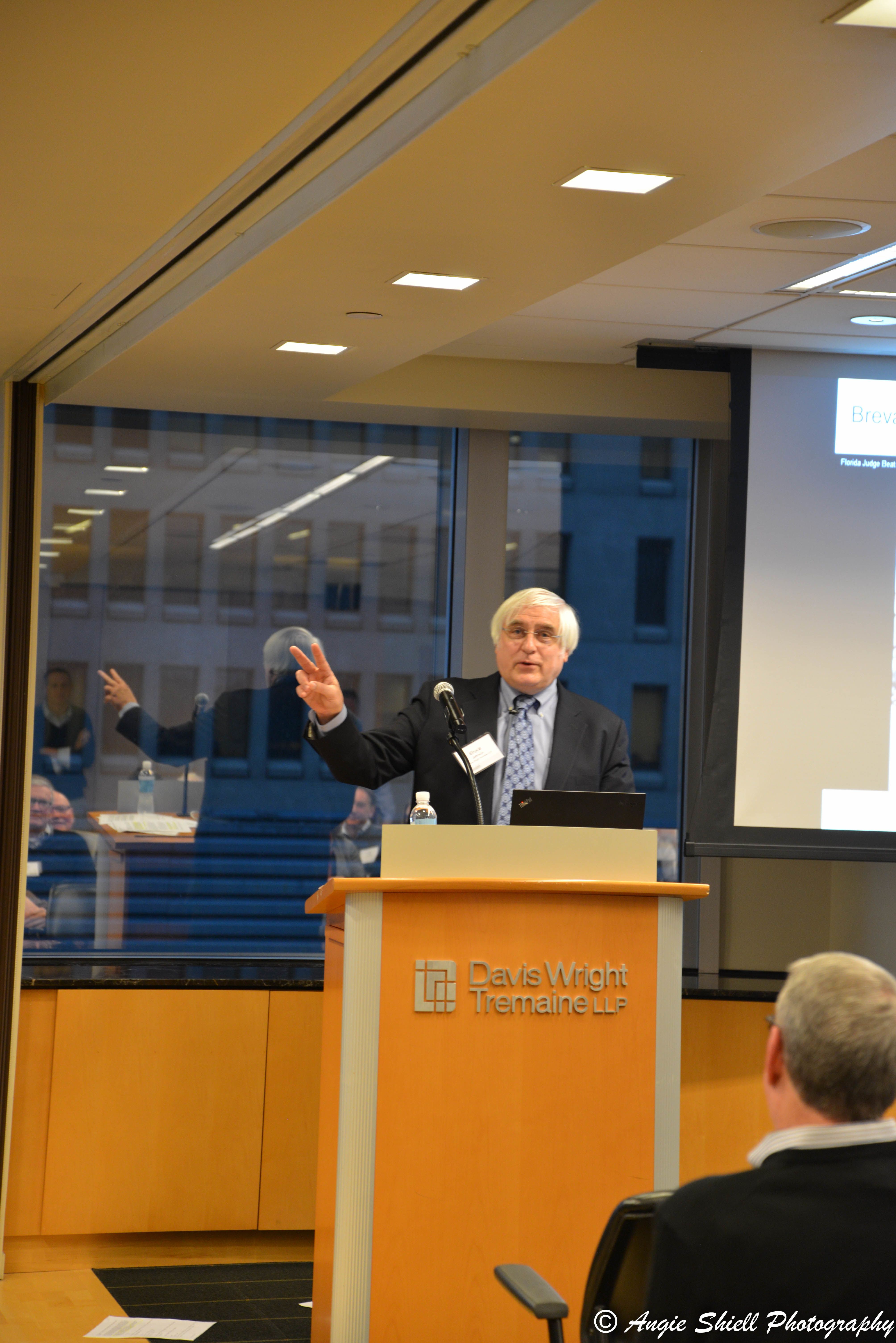 Bruce E.H. Johnson speaking in front of an audience